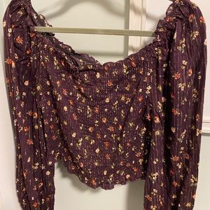 Burgundy blouse, sits off shoulder and is cropped length